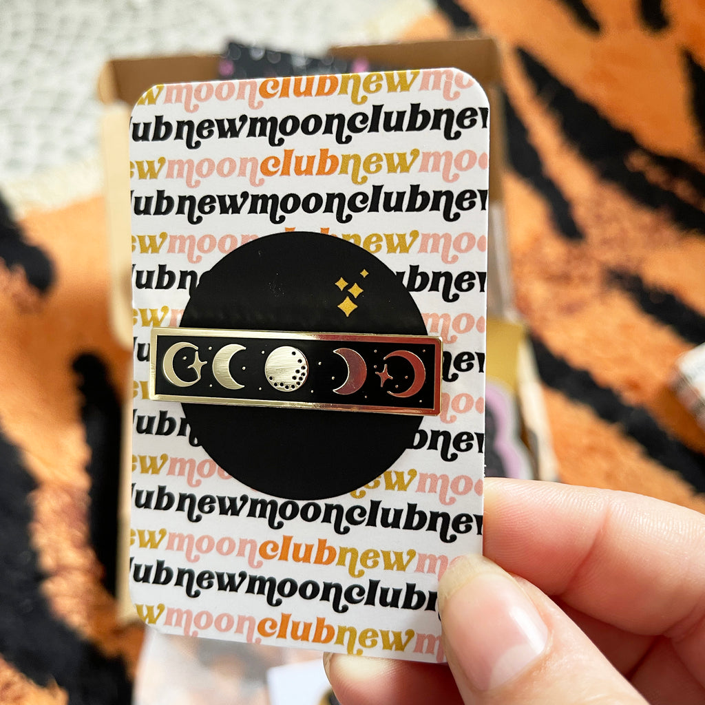 hand holding moon phases enamel pin badge in card 